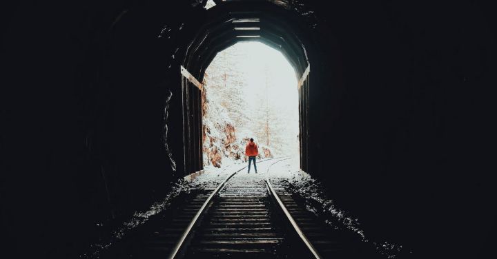 Winter Railway - Person Standing on Train Track