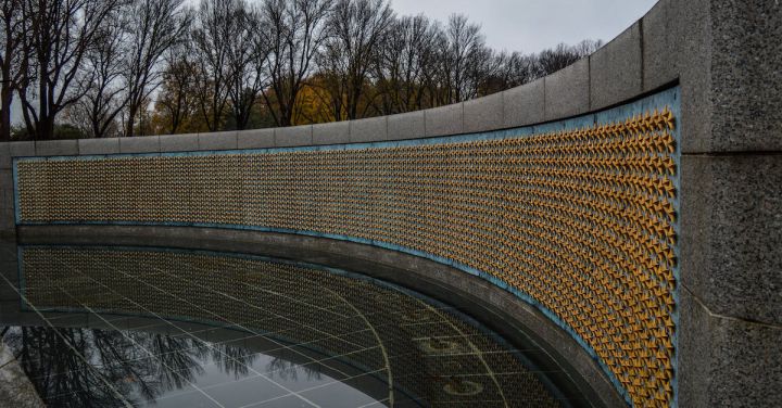 World War - Golden stars on Freedom Wall at World War II Memorial located in in National Mall in Washington DC against gloomy sky