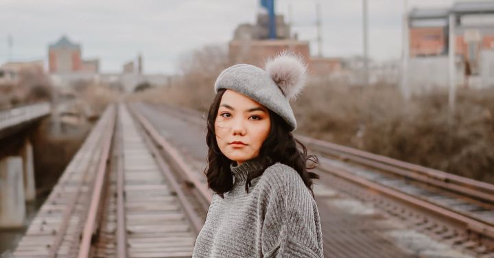 Model Railways - Woman in Gray Knit Sweater and Blue Denim Jeans Standing on Train Rail
