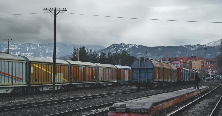 Freight Train - Train Running on Train Track Under Gray Sky at Daytime