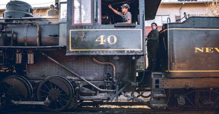 Steam Engine - People in old locomotive on railroad
