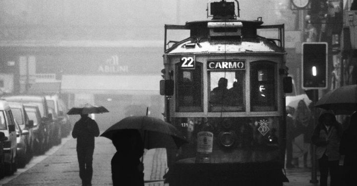 Troop Train - Grayscale Photography of Person Crossing Street Near a Tram